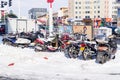 Mopeds and motor scooters and motobikes and motorcycles are many in the snow