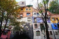 Hundertwasser house in Vienna, Austria. The Hundertwasserhaus apartment block has colorful facade, undulating floors, a roof Royalty Free Stock Photo