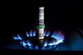 A hundred dollar bill on a gas burner with a burning fire on a black background, the front and back background is blurred with a Royalty Free Stock Photo