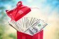 Hundred dollar bills in a big red present box Royalty Free Stock Photo