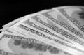 Hundred dollar bills on a dark background, black and white Royalty Free Stock Photo