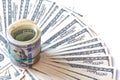 Hundred dollar bills rolled up with rubberband on dollar bills background Royalty Free Stock Photo
