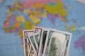 Hundred dollar and fifty dollar bills. Against the background of a world map. It shows the silhouette of Africa and Asia Royalty Free Stock Photo