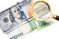 Hundred dollar under a magnifying glass on the bacdrop euro banknotes. Royalty Free Stock Photo