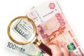 Hundred dollar under a magnifying glass on the bacdrop euro and ruble banknotes. Royalty Free Stock Photo