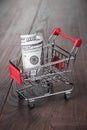 A hundred dollars in the shopping trolley Royalty Free Stock Photo