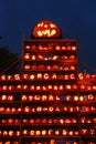 Hundreds of carved pumpkins tower into the sky