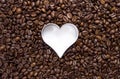 Hundreds of coffee beans with a heart cutter Royalty Free Stock Photo