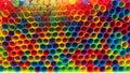 Close up on front openings of hundreds of colorful plastic straws