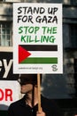 Protest messages on placards and posters at the Gaza: Stop The Massacre rally in Whitehall, London, UK.