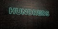 HUNDREDS -Realistic Neon Sign on Brick Wall background - 3D rendered royalty free stock image