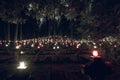 Hundreds of Small Candles Glowing in the Cemetery