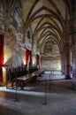 Hunedoara, Romania - May 3, 2019: Inside Corvin castle. Vintage throne room interior with old wooden seats and long wooden table, Royalty Free Stock Photo