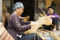 Hung Yen, Vietnam - July 26, 2015: Old women weaves bamboo fish trap at Vietnamese traditional crafts village Thu Sy, Hung Yen pro