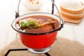 Hungarian carp soup in a kettle and sour salad Royalty Free Stock Photo