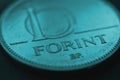 Hungarian coin of 10 forints lies on dark surface closeup. Money of Hungary. News about economy or currency. Tax and inflation.