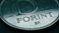 Hungarian coin of 10 forints lies on dark surface closeup. Money of Hungary. News about economy or finance. Loan and credit.