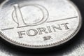 Hungarian coin of 10 forints lies on textured surface close-up. Money of Hungary. News about economy or finance. Loan and credit.