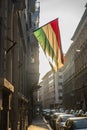 Hungarian flag hanging outside a building backlit by the sun