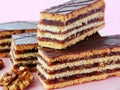 Hungarian Gerbeaud layered cake with walnut and apricot jam filling, covered with chocolate zserbo Royalty Free Stock Photo