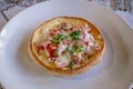 Hungarian pancakes langos with ham and cheese close-up on the table