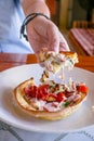 Hungarian pancakes langos with ham and cheese close-up on the table