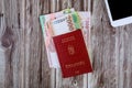 The Hungarian passports and banknotes on a forint paper money and digital tablet