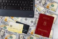 The Hungarian passports buy online tickets using credit cards in the laptop keyboard on US dollars banknotes a background