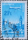 Hungary circa 1966: A post stamp printed in Hungary showing an Airpost Plane over the City of London served by Hungarian Airways Royalty Free Stock Photo