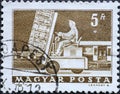 Hungary circa 1964: A post stamp printed in Hungary showing a man on a loaded forklifter Hydraulic lift truck & mail car