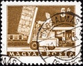 HUNGARY - CIRCA 1964: A stamp printed in Hungary shows Hydraulic lift truck and mail car, circa 1964.