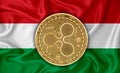 Hungary flag, ripple gold coin on flag background. The concept of blockchain, bitcoin, currency decentralization in the country. Royalty Free Stock Photo
