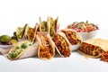 hunger-inducing shot of delicious tacos, burritos, and nachos on white background