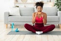 Hungry African Girl Eating Burger During Fitness Workout At Home