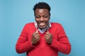 Hungry african man holding fork and knife raised waiting for dinner Royalty Free Stock Photo