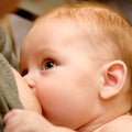 Hungry baby breast feeding closeup Royalty Free Stock Photo