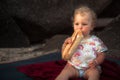 Hungry baby girl eating baguette bread countryside rustic lifestyle copy space Royalty Free Stock Photo