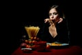 Hungry beautiful woman eat on noodles spaghetti on black background.