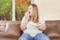 Hungry blonde woman eats donuts Royalty Free Stock Photo