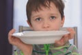 Hungry boy with beautiful eyes waiting for dinner Royalty Free Stock Photo