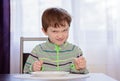 Hungry boy child waiting for dinner Royalty Free Stock Photo