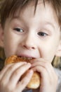 Hungry boy eats with opened mouth Royalty Free Stock Photo