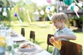 Hungry boy looking at a plate full of grilled dishes on the table. Royalty Free Stock Photo