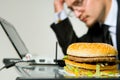 Hungry businessman eating hamburger