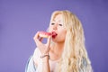 Photo of female holds sweet delicious doughnut