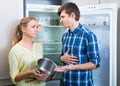 Hungry couple near empty fridge