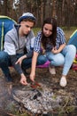 Hungry couple roasts sausages at the stake Royalty Free Stock Photo