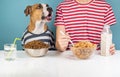 Hungry dog and human having breakfast together. Minimalistic ill Royalty Free Stock Photo