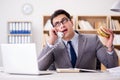 The hungry funny businessman eating junk food sandwich Royalty Free Stock Photo