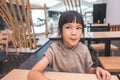 Hungry child licking her lip waiting for food in restaurant Royalty Free Stock Photo